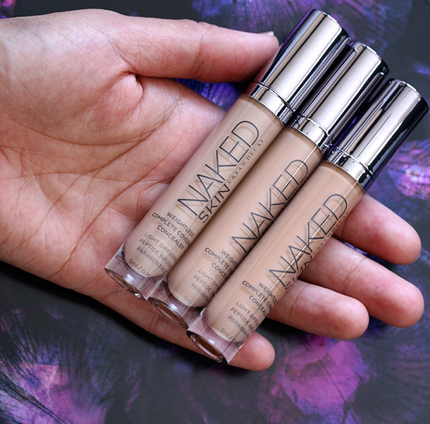 Urban Decay Naked Skin Weightless Complete Coverage Concealers from the left in Medium Light Neutral, Medium Neutral and Medium Dark Warm